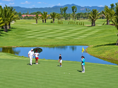 North Hill Golf Chiang Mai – 18 Holes with Private Transfers 3 Golfers putting beside a lake at North Hill Golf Chiang Mai