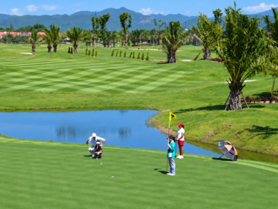North Hill Golf Chiang Mai – 18 Holes with Private Transfers 2 Golfers putting beside a lake at North Hill Golf Chiang Mai